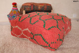 red pouf with green trellis